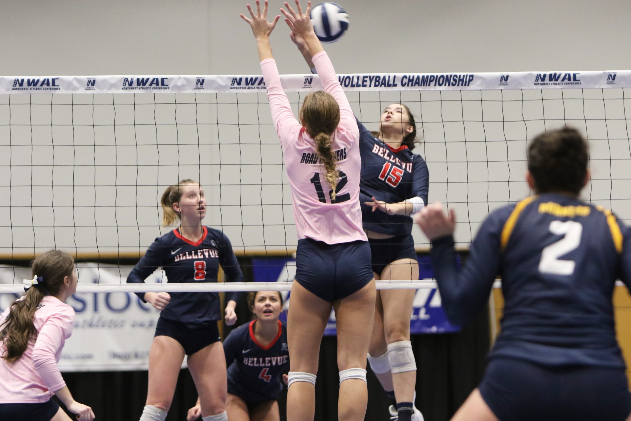 A BC player hits a shot at the net against a defender
