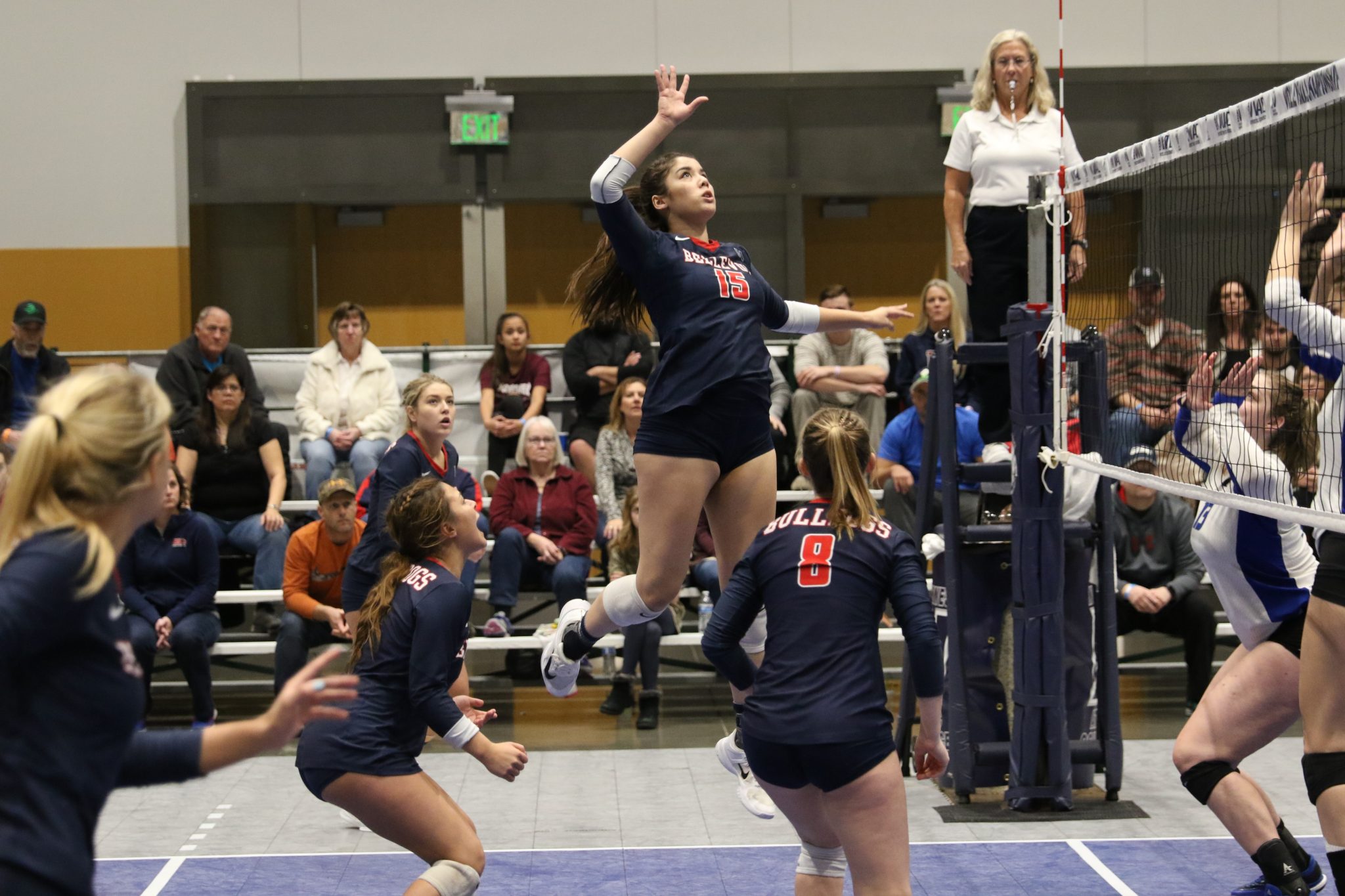A BC player jumps above the net