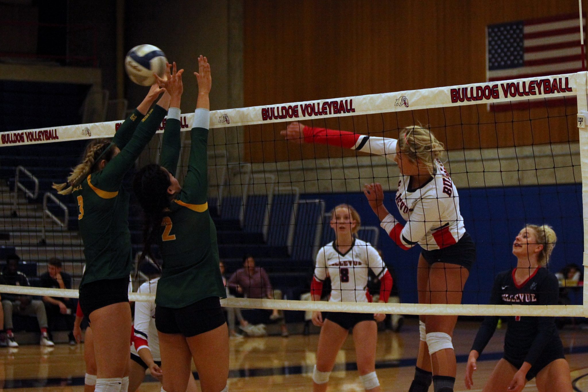 A BC player hits a shot over the net