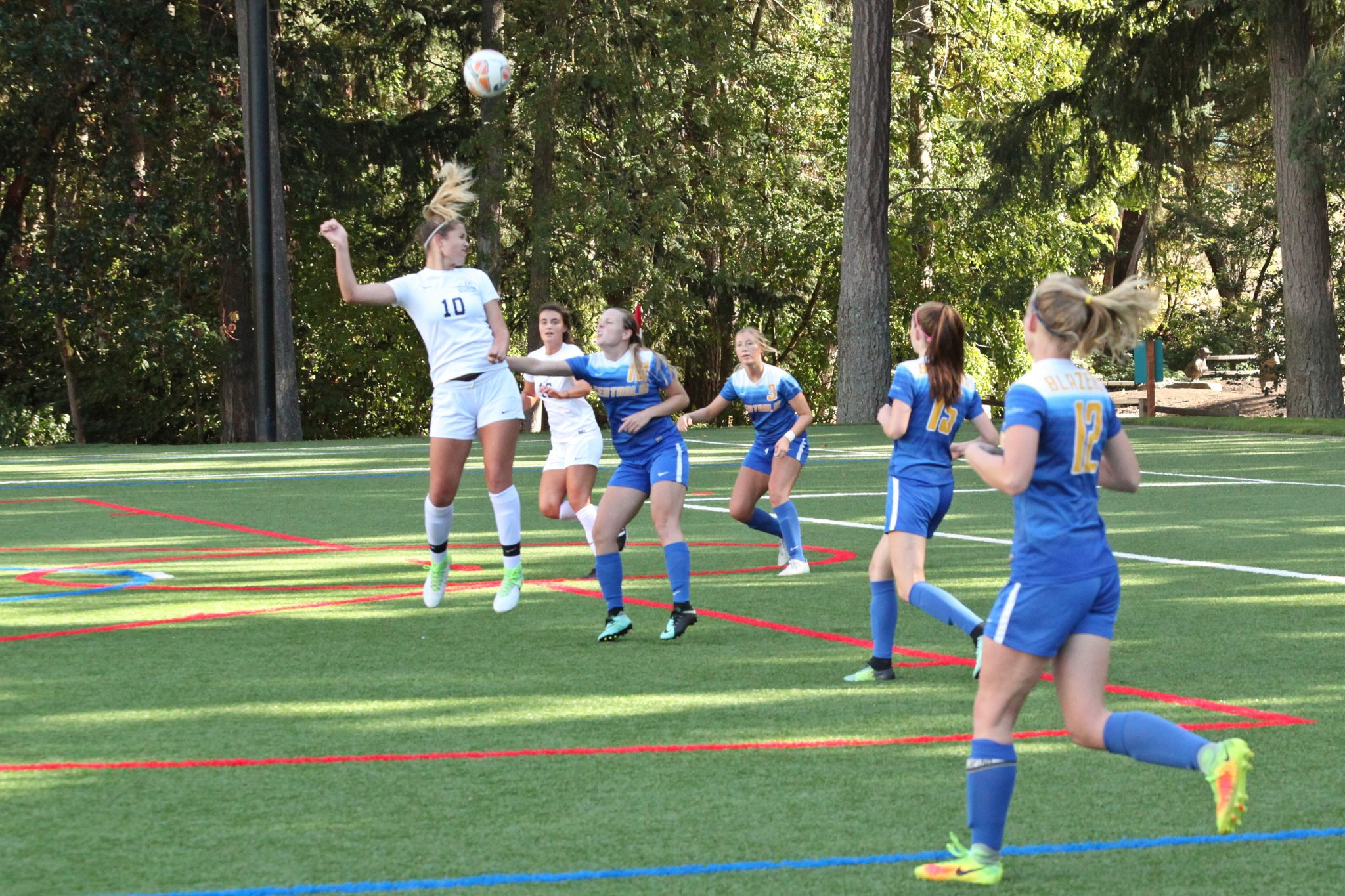 A BC player heads the ball