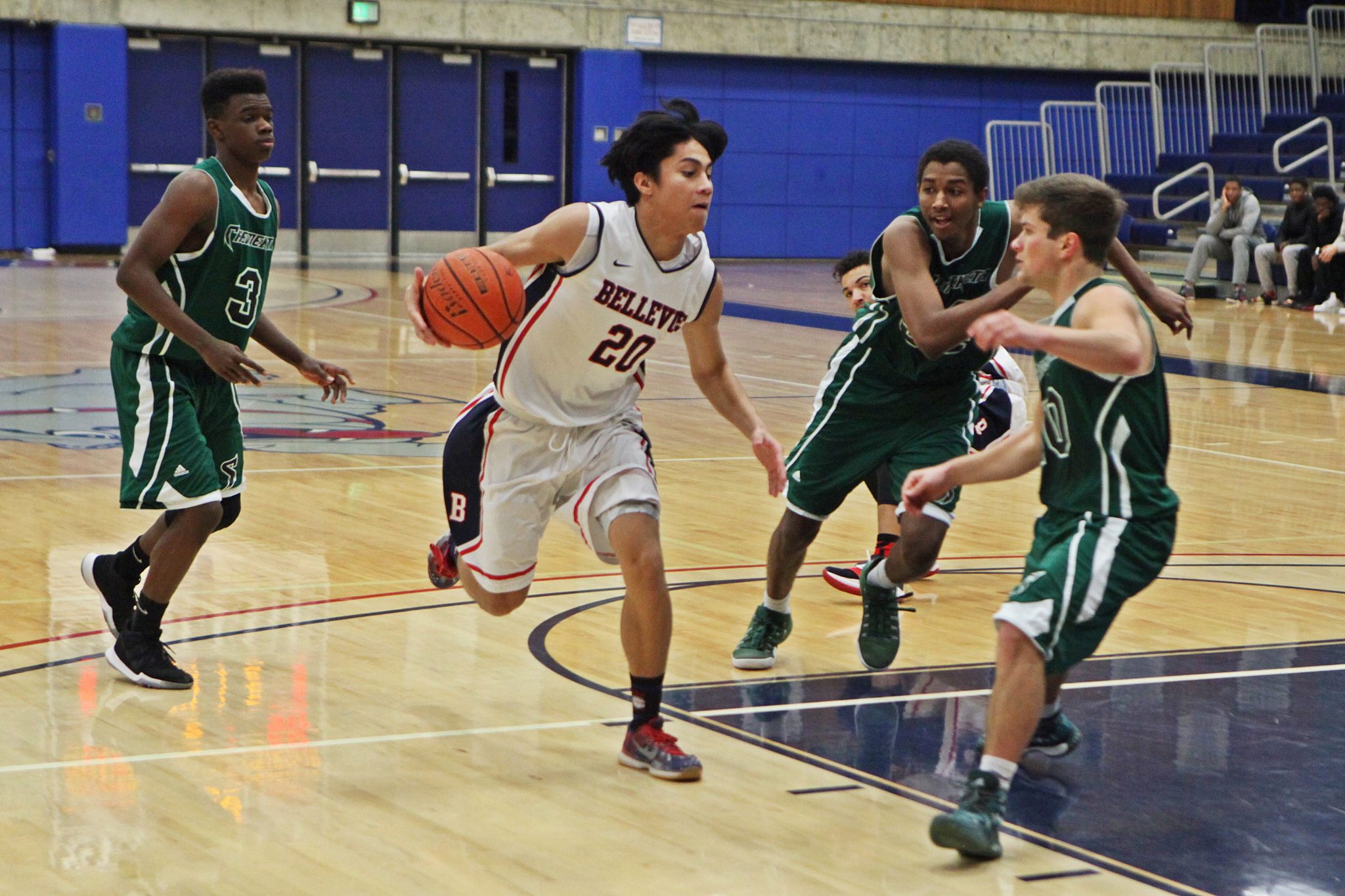 A BC men's basketball player drives against a defender