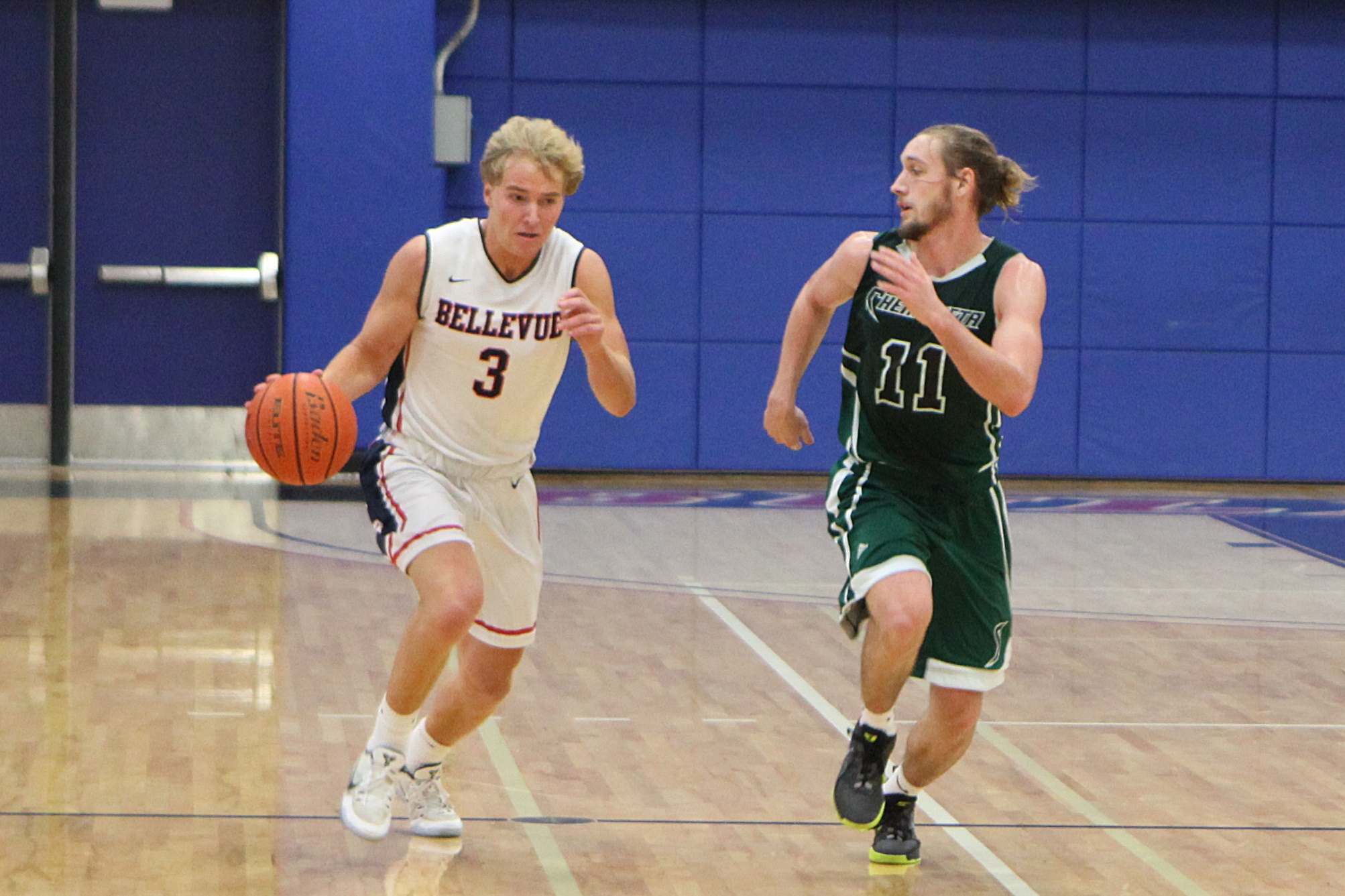 A BC men's basketball player drives against a defender