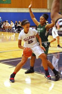 A BC player dribbles while guarded by a defender