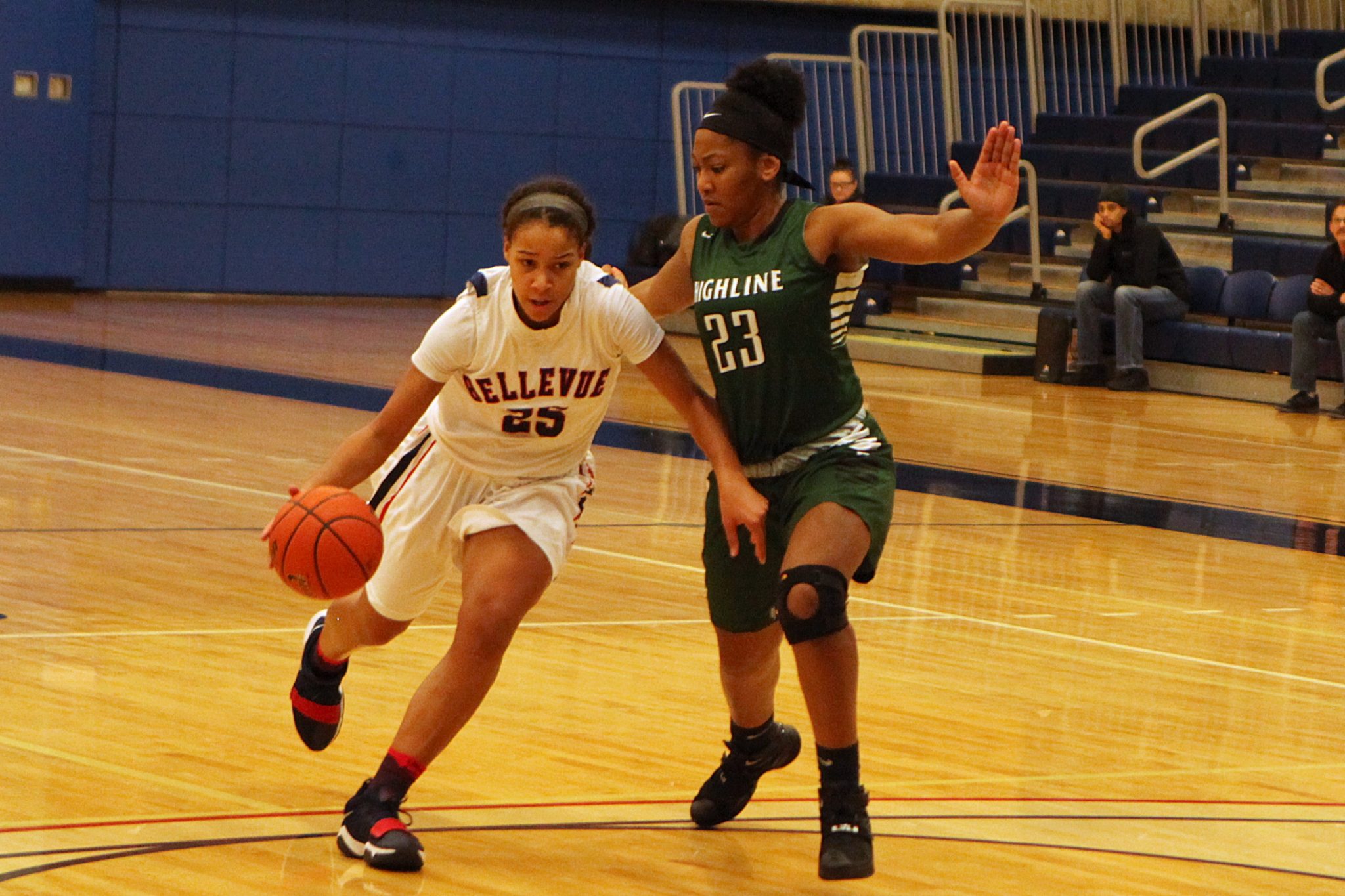 A BC player dribbles the ball against a defender