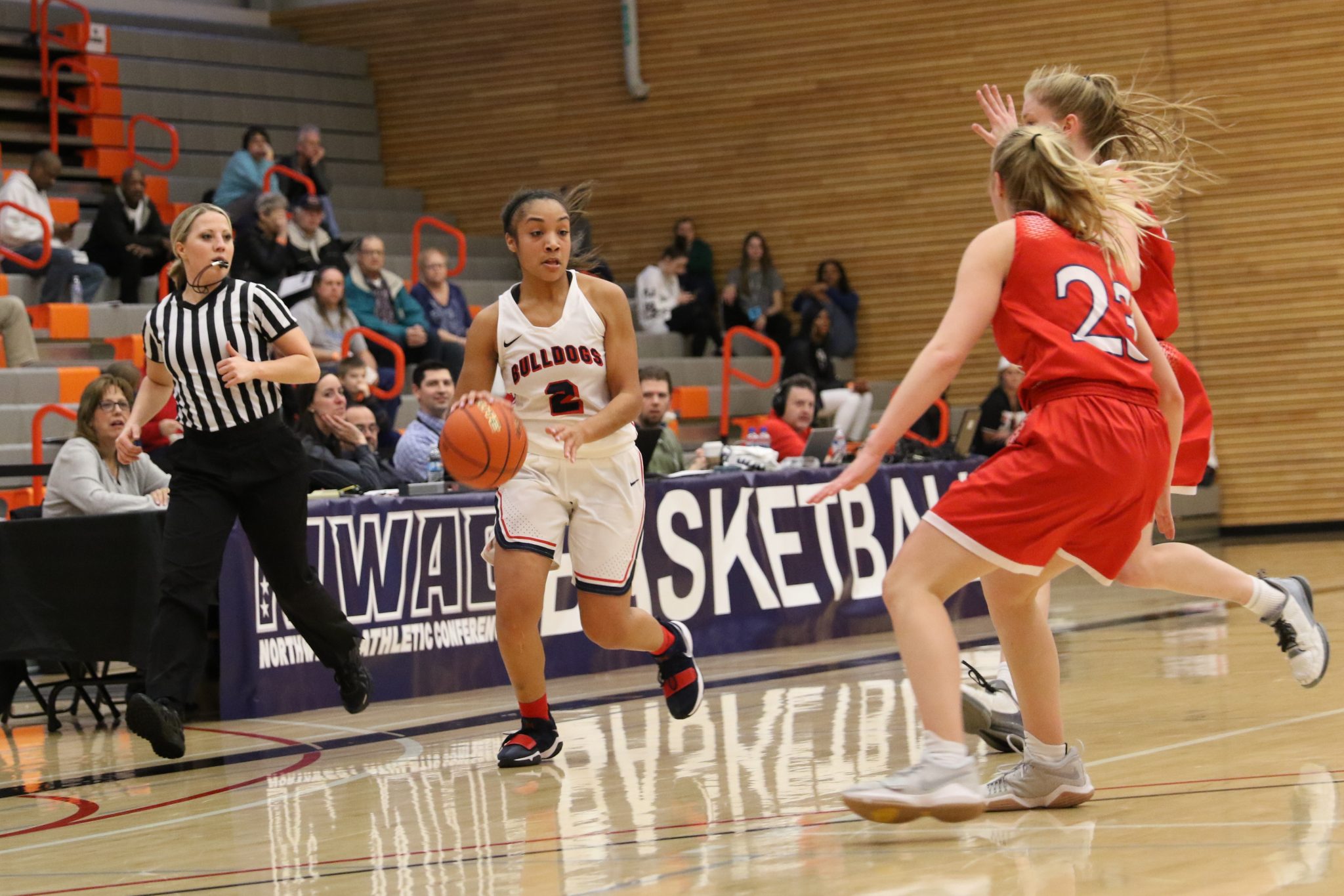 A BC player dribbles the ball against a defener