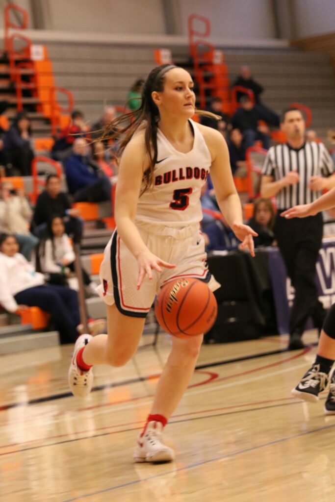 A BC player dribbles the ball past a defender