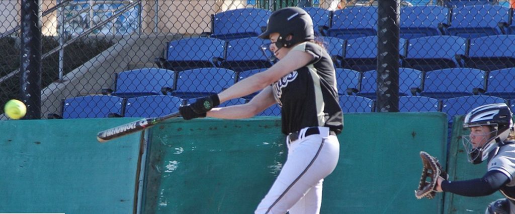 Former BC player Rachael Delamare takes a swing at the ball