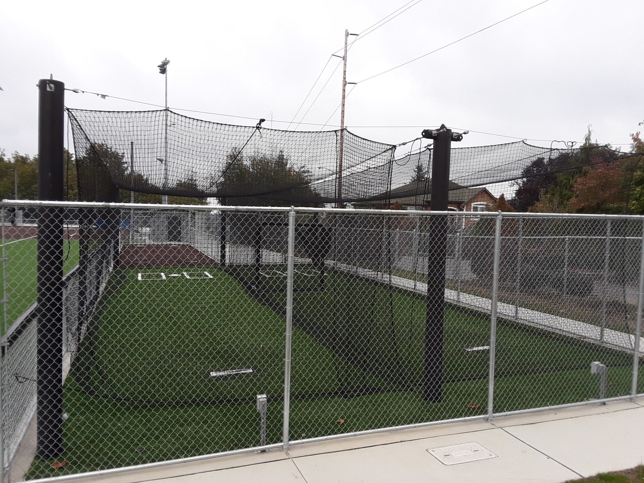 Softball field warm-up area and overhead netting