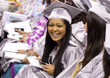 Student in cap and gown at graduation ceremony