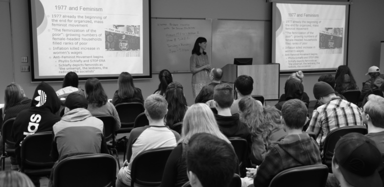 Professor Devon Atchison deilvering a history lecture to students