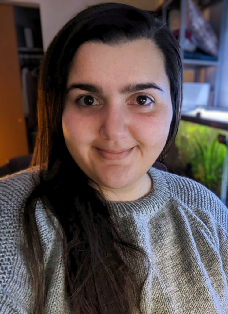 A head shot of Jessica Ryan wearing a hand knit sweater. 