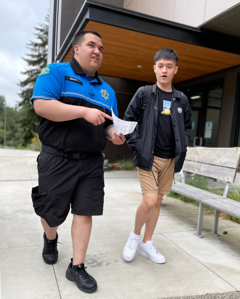 Picture of Officer escorting Student by the U Building