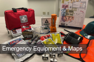 emergency equipment, flashlight,, safety goggles, radios, first aid kit, and other emergency supplies displayed on a table