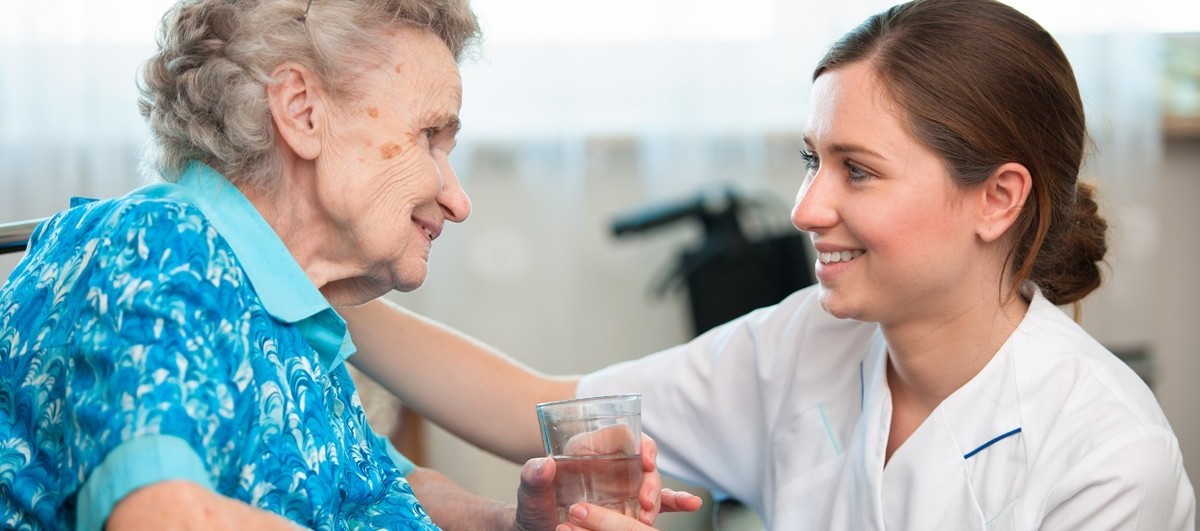 nurse assisting elderly patient