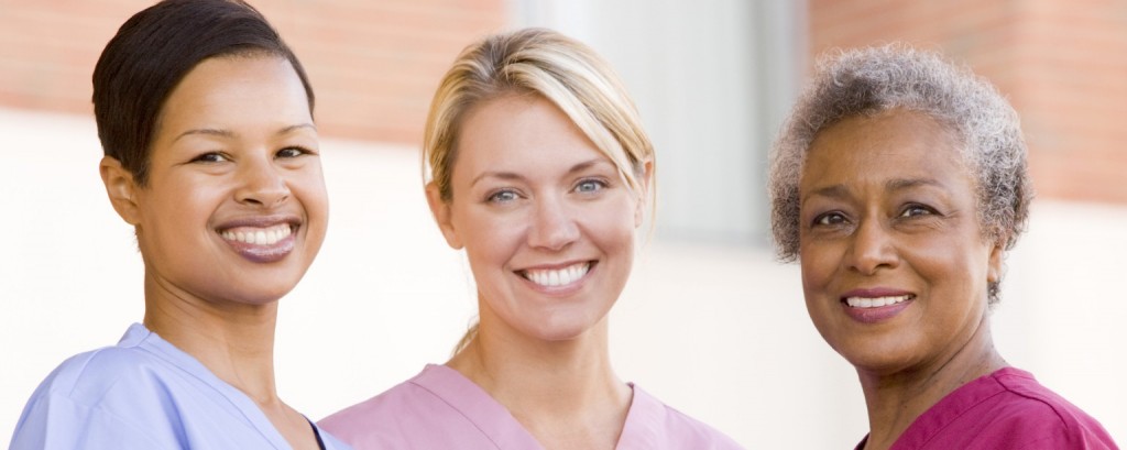 Three women in nursing scrubs