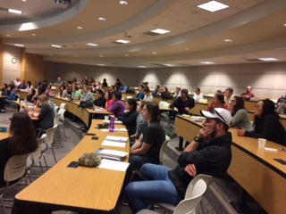 Photo of students in a lecture hall watching an MBS seminar.