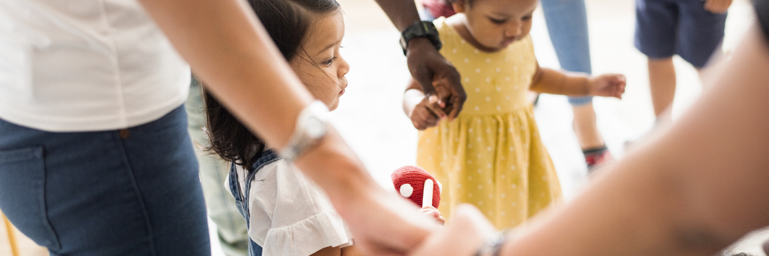 children and teacher holding hands