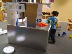 children building a styrofoam house