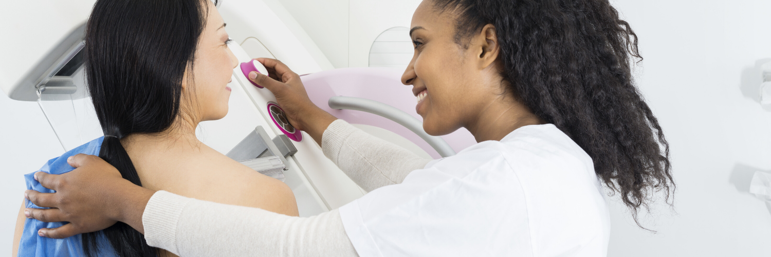 Woman providing mammogram to patient