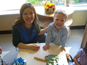 Picture of student working with child.