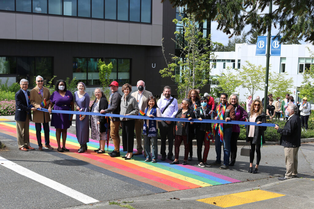 Cutting the ribbon at the rainbow crosswalk dedication