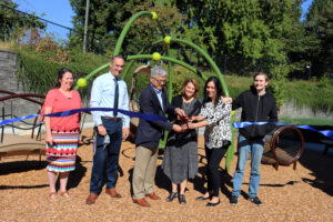 Gary Locke and Sheri Flies cut a ribbon to celebrate the ELC playground renovation on September 6.