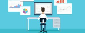 Graphic of person at computer desk in front of data analytics charts