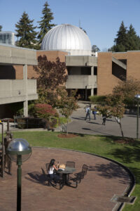 A view of the Bellevue College campus, with the planetarium dome visible across a courtyard.