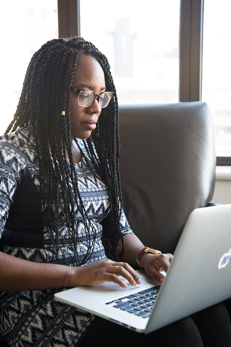 A woman works on her laptop.