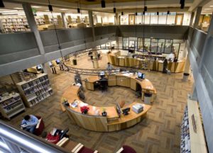 Photo taken from the 2nd floor of the library looking down onto the help desk on the 1st floor of the library.