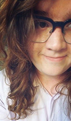 photo of young woman with long reddish hair and glasses