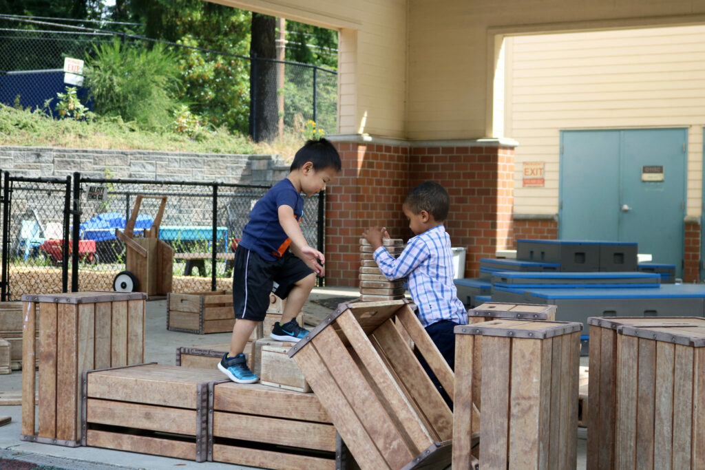 Two boys building outside