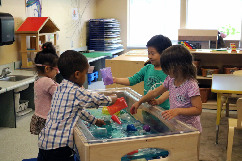 Preschoolers playing with water