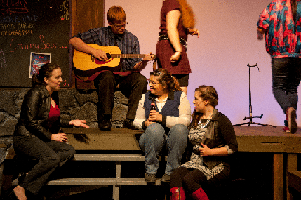 Entanglement Theory - a group of people singing on the porch while a male character is playing the character