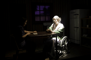 The Shadow Box scene with two woman sitting at table