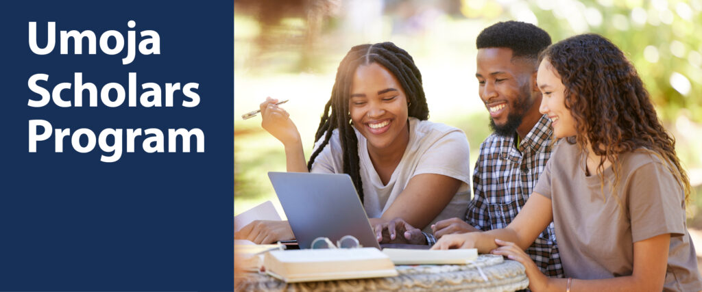 Two Black/African American women and one Black/African American man seated together in front of a laptop