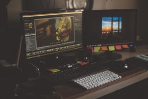 desk setup with two computer monitors running visual design programs