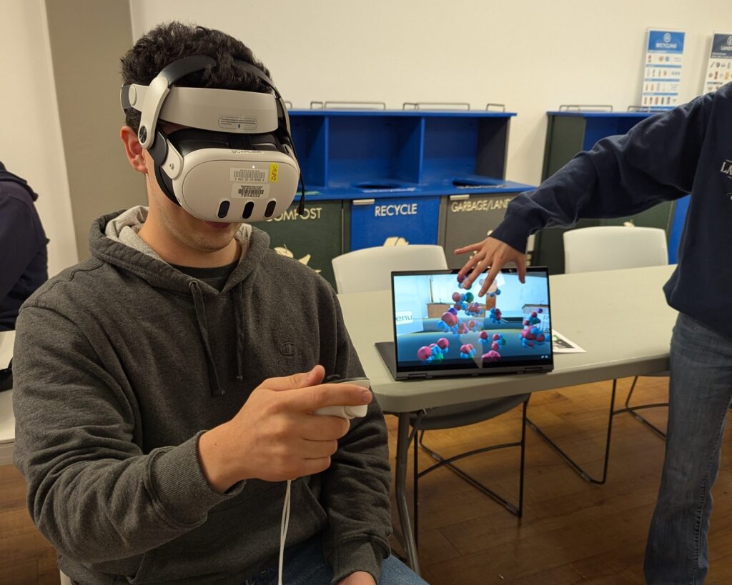 Student wearing a headset and testing out a VR application